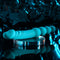 Blue silicone dual-end vibrator on a clear display, showcasing textured shaft and beaded tip for versatile pleasure.