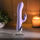 Spinderella Rechargeable Silicone Rabbit Vibrator Purple displayed with soft lighting and greenery.