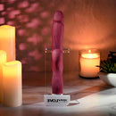 Bursting with Pleasure Inflatable Dual Rabbit Vibrator Red displayed on a countertop with candles and plants.