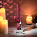 Bursting with Pleasure Inflatable Dual Rabbit Vibrator Red displayed among candles and soft lighting.