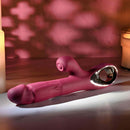 Bursting with Pleasure Inflatable Dual Rabbit Vibrator Red shown in a softly lit setting.