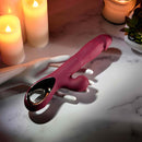 Bursting with Pleasure Inflatable Dual Rabbit Vibrator Red on a marble surface with candles.
