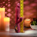 Bursting with Pleasure Inflatable Dual Rabbit Vibrator Red next to a measuring tape, featuring vibrant design and intimate detail.