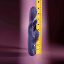Bow Down Vibrator with Clitoral Stimulator Purple next to a measuring tape for size comparison.