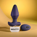Starburst Expandable Anal Plug with Remote Purple next to its remote control on a yellow backdrop.