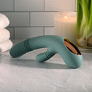 Evolved Rub Me Tender G-spot Clitoral Stimulator on a countertop with candles and towels.