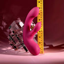 Gentle Persuasion Vibrator with Clitoral Stimulator Red next to measuring tape for size comparison.