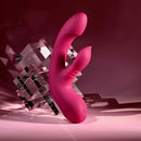 Gentle Persuasion Vibrator with Clitoral Stimulator Red resting on a reflective surface, showcasing its sleek design.