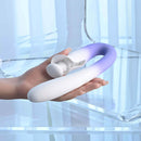 Spring Loaded Rechargeable Silicone Dual Vibrator Purple held in hand on a clear surface, showcasing its innovative design.