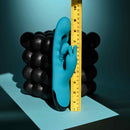 Bunny Tapper Tapping Rabbit Vibrator Blue with measuring tape on a textured black background.