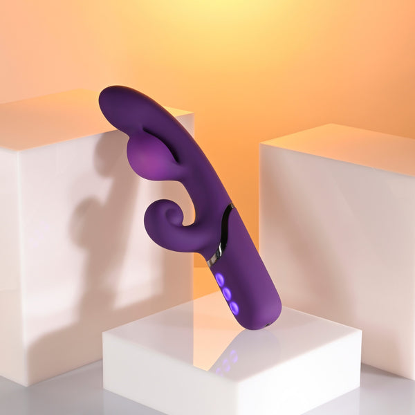 Pleasure Puff Silicone Expandable Rabbit Vibrator Purple displayed on modern pedestals with a soft background.