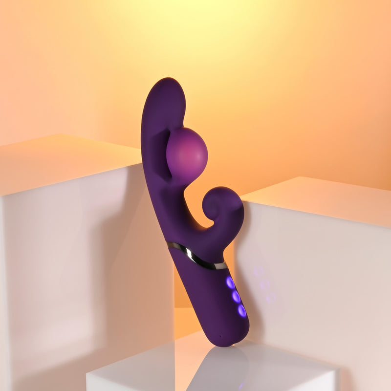 Pleasure Puff Silicone Expandable Rabbit Vibrator Purple displayed on a modern pedestal with a soft glowing background.