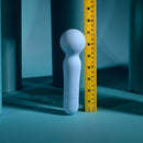 Iris Rechargeable Silicone Wand Blue next to a measuring tape on a blue background, showcasing its sleek design.