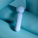 Iris Rechargeable Silicone Wand Blue on a soft blue background, showcasing its sleek design and softness.