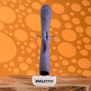Poppin Good Time Rechargeable Rabbit Vibrator Purple displayed on a wooden surface with a vibrant orange background.