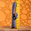 Poppin Good Time Rechargeable Rabbit Vibrator Purple with a ruler for size reference on a wooden surface