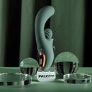 Spiral Charm Rechargeable Clitoral Stimulator Green displayed among glass spheres.