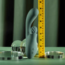 Spiral Charm Rechargeable Clitoral Stimulator Green displayed next to a ruler for size comparison.
