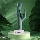 Satin Swirl Rabbit Vibrator with Clitoral Stimulator Green displayed on a pastel pedestal with green foliage background.