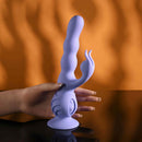 Wiggly Bunny Rechargeable Rabbit Vibrator Purple held in hand against an orange background showcasing its unique design.