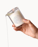Dame Massage Oil Candle Wild Lust being poured, showcasing its plant-based wax and sensuous design in a hand.