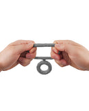 Hands holding the Shaft Double C-Ring Large Gray, showcasing its dual-loop design and FLEXISKIN silicone material.
