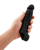 Shaft Model F Sheath Size 1 Black held in hand, showcasing its realistic design and FLEXISKIN material.