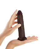 Shaft Model J Flexskin Silicone 7.5 Inch Dong Mahogany held in hands showcasing its realistic design and texture.