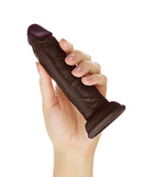 Shaft Model J Flexskin Silicone 5.5 Inch Dong Mahogany held in hand, showcasing its lifelike design and rich tone.