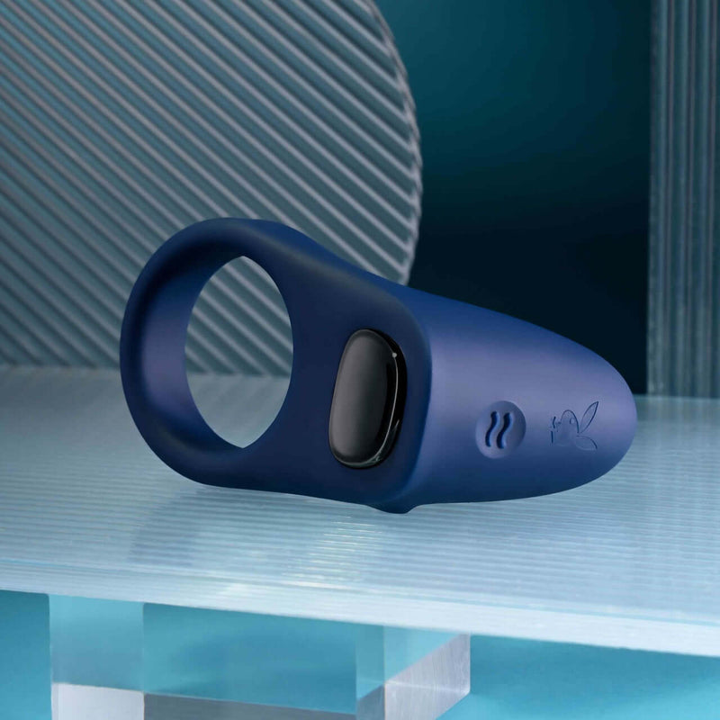 Playboy Pleasure Point Vibrating Penis Ring in navy blue, crafted from body-safe silicone with 10 speeds, enhancing pleasure and longevity.