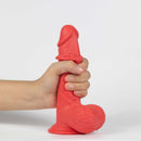 Get Lucky Real Skin Mr Ruby 7.5 Inch Dual Layer Dildo Red held in hand for a realistic experience.