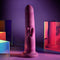 PLAYBOY Fluffle Rabbit Vibrator in purple showcased with colorful reflective surfaces in the background