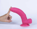 Get Lucky Real Skin Mr Pink 7.5 Inch Dual Layer Dildo being touched with a finger, showcasing its realistic design.