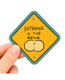Sleazy Greetings Entrance In The Rear Funny Vinyl Sticker held by a hand, featuring humorous design and cheeky message.