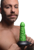 Radioactive Reptile Thick Scaly Silicone Dildo Green held by a person, showcasing its thick, scale-textured design.
