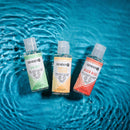Gender X Flavored Lube Travel 3-Pack featuring Spa Bit, Tropical Fusion, and Peach Bliss on a water background.