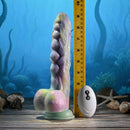 Gender X Monsters Ball Thrusting Vibrating Dildo with Remote Control next to a ruler for size comparison.