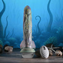 Gender X Monsters Ball Thrusting Vibrating Dildo with Remote Control on a beach setting with shells.