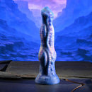 Gender X Wildest Dreams Vibrating Dildo with Remote Control displayed against a stunning galaxy-themed background.