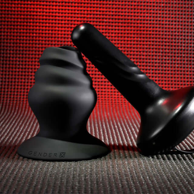 Gender X Echo Vibrator with textured silicone sleeve and 10 vibration speeds, shown against a red backdrop.