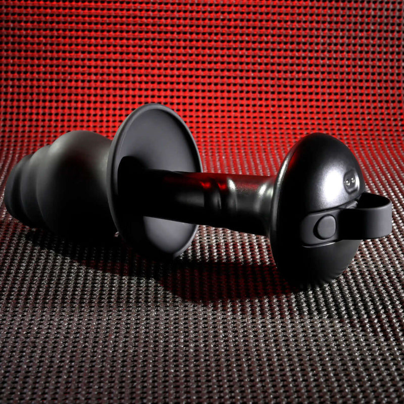 Gender X Echo Vibrator with Silicone Sleeve featuring 10 vibration speeds and waterproof design against a red textured background