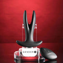 Gender X Spread The Love Vibrating Anal Plug with Remote Control Black displayed on a clear stand with remote.