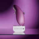 Gender X BJ Buddy Hand Vibrator Purple displayed on a stand with a vibrant purple background.