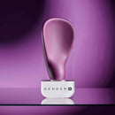 Gender X BJ Buddy Hand Vibrator Purple on a sleek display with a vibrant purple background.