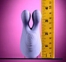Selopa Handsy Rechargeable Vibrator Purple next to a ruler for size reference on a pink background.
