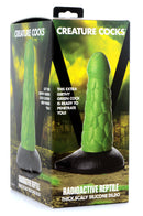 Radioactive Reptile Thick Scaly Silicone Dildo Green in packaging with scale texture and vibrant green color.