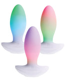Paradise Illumination THE Plug Vibrator in three vibrant colors displayed on a white background.