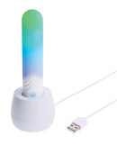 Paradise Illumination THE Bullet Vibrator charging in a stylish white base with colorful light.
