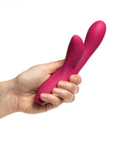 Person holding the Je Joue Hera Rabbit Vibrator Fuchsia, showcasing its sleek design and dual stimulation features.