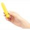 Hand holding a yellow JAGUAR Vibrator by MAIA Toys, featuring a sleek design with 10 vibration levels, waterproof and rechargeable.